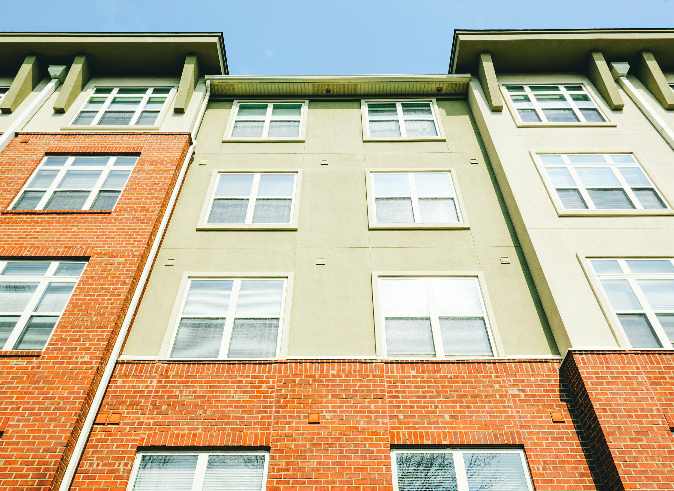 Apartment building facade against a blue sky